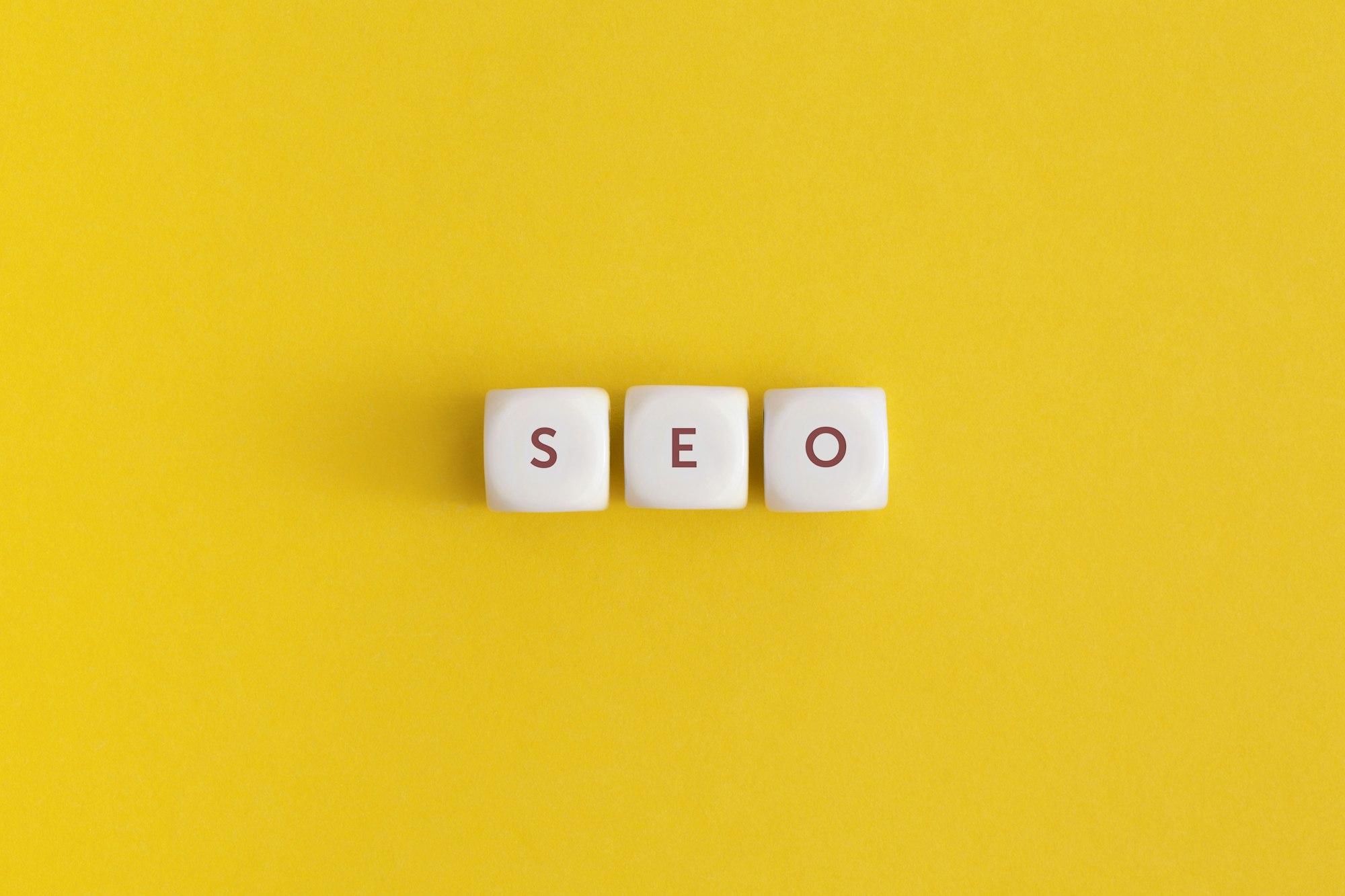 The word seo on yellow background. Top view. Flat lay.